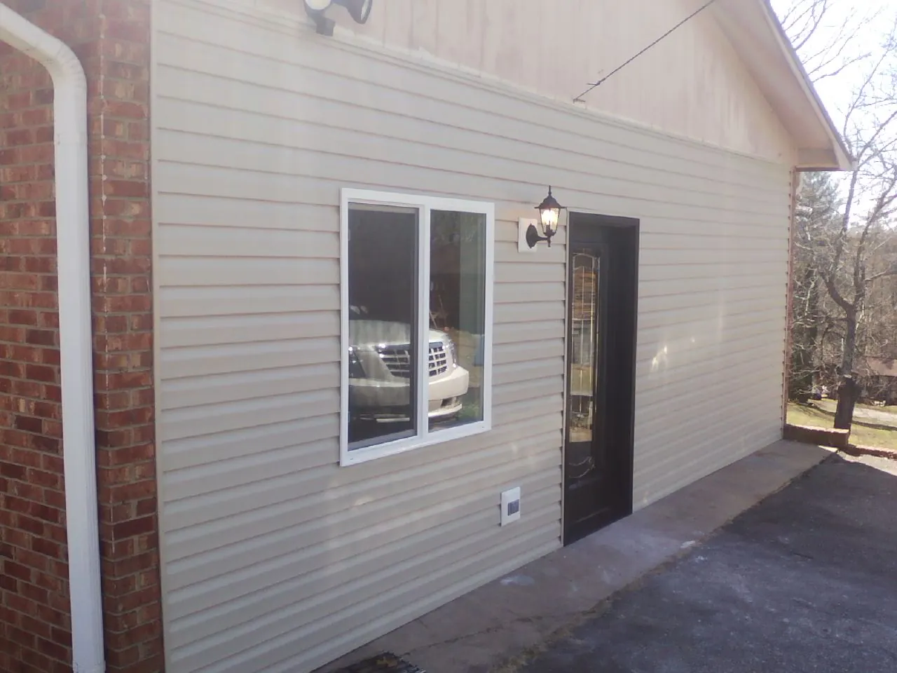 New vinyl siding and entry door on a room addition in Crestline